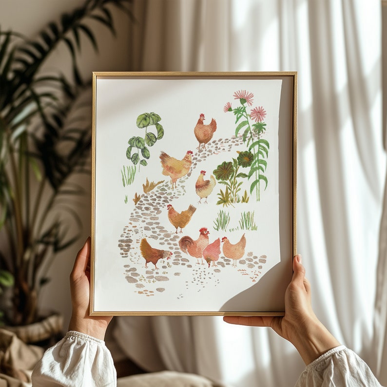 Op de afbeelding: Een aquarel schilderij van een groep kippen die op een pad lopen met groene planten en bloemen. De kippen zijn bruin en wit met rode kammen. Het schilderij is ingelijst in een gouden lijst.