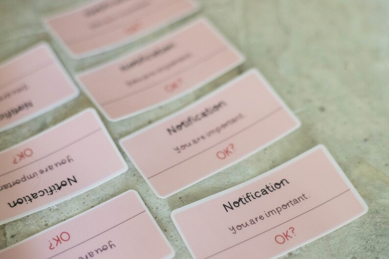 May include: Pink notification cards with the text "Notification You are important. OK?" repeated on each card.