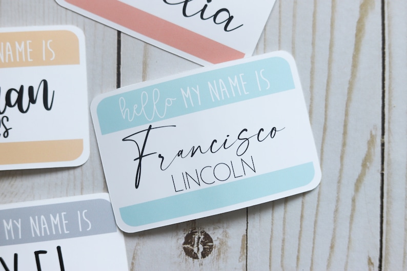 May include: A blue and white name tag with the text "hello my name is Francisco LINCOLN" in black cursive writing.