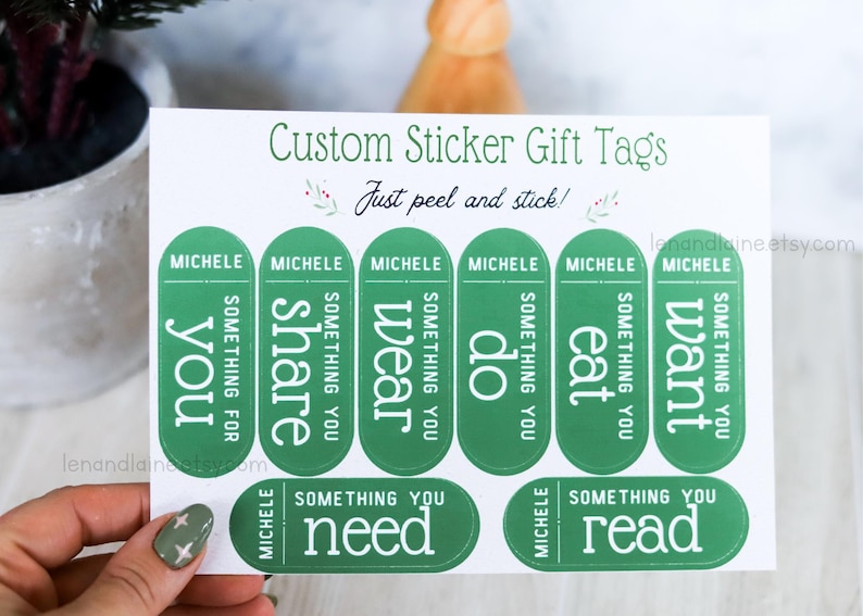 May include: Green sticker gift tags with the text "Custom Sticker Gift Tags" and "Just peel and stick!" printed on a white background. The tags are labeled with the name "Michele" and the words "you", "share", "wear", "do", "eat", "want", "need", and "read".