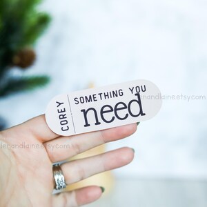 May include: White sticker with black text that reads "Corey Something You Need" and a website address.