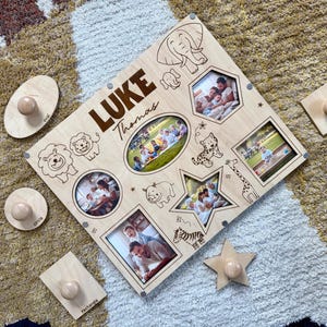 May include: Wooden personalized photo puzzle with the name "Luke Thomas" and various animal illustrations. Includes oval, circle, rectangle, and star-shaped wooden pieces with knobs. The puzzle features multiple photo frames.