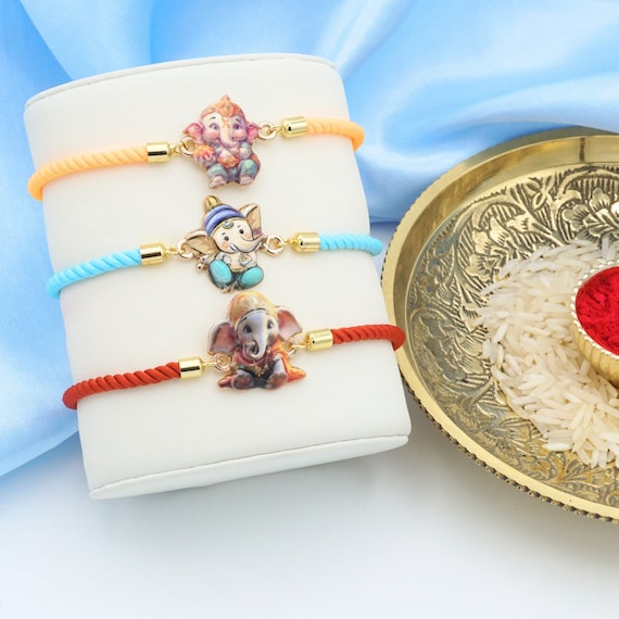 UtseWe Ganesha Rakhi Bracelet | Divine Ganeshji Rakhi | Ganapati Rakhari - Includes Roli,  Chawal