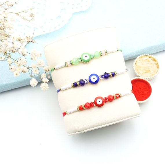 UtseWe Rakhi Set | Set of 3 Colorful Evil Eye Rakhis With Roli Chawal