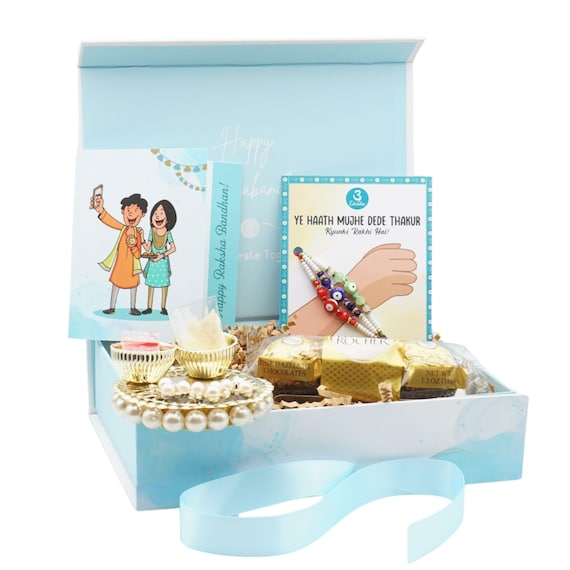 UtseWe Evil Eye Rakhi Gift Box includes 3 Rakhis, Roli-Chawal, Thali, Chocolate, & Card | Rakhri
