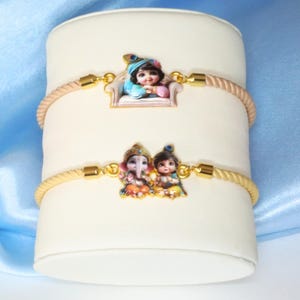 UtsaWe Rakhi | Charming Krishna and Radha Motif Rakhi with Teal Cord | Perfect for Brothers of All Ages |  Includes Roli and Chawal