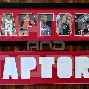 May include: A framed black and red sign with the word "RAPTORS" spelled out in white letters. Each letter is filled with a different photo of a basketball player wearing a red and black jersey.