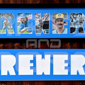 May include: A framed blue and white sign with the word "Brewers" spelled out in white letters. Each letter is filled with a different photo of a baseball player wearing a blue and yellow uniform.