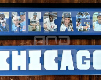 May include: A framed photo collage of Chicago Cubs baseball players. The word "CHICAGO" is spelled out with each letter containing a different player's photo. The frame is black with a blue mat. Below the frame is a blue sign with the word "CHICAGO" cut out in white.