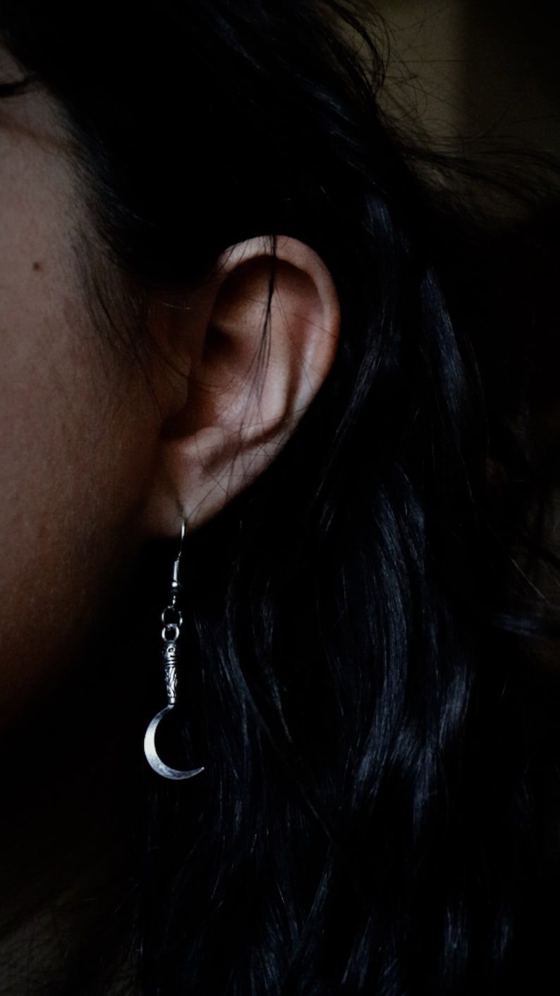 a pair of sickle/scythe earrings for herbalists and witches.