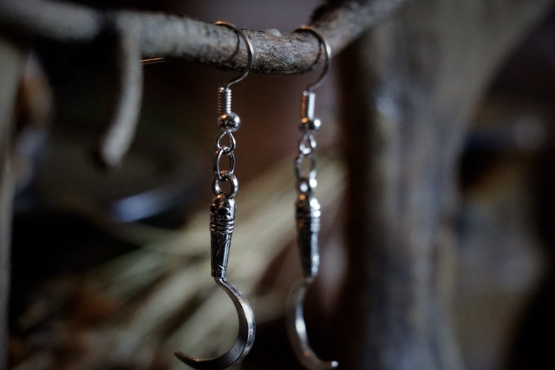 a pair of sickle/scythe earrings for herbalists and witches.