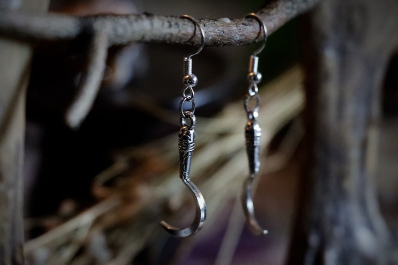 a pair of sickle/scythe earrings for herbalists and witches.