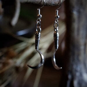 a pair of sickle/scythe earrings for herbalists and witches.