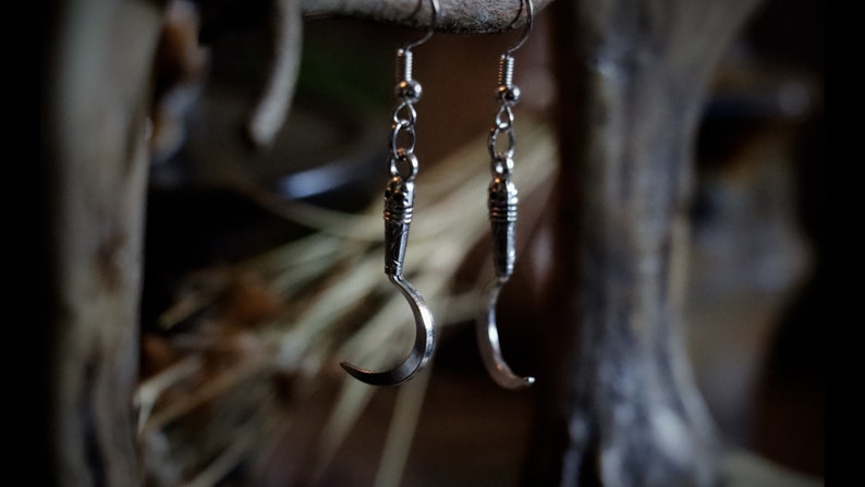 a pair of sickle/scythe earrings for herbalists and witches.