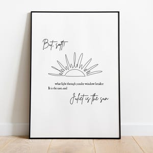 May include: Black framed art print with the quote "But, soft! what light through yonder window breaks? It is the east, and Juliet is the sun" in a handwritten style font. A line drawing of a sun is above the quote.