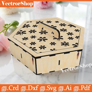 May include: A light-colored wooden hexagonal box with a handle and a lid decorated with flower cutouts. The box has a black trim and is sitting on a white surface. The text "VectorShop" is visible.