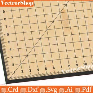 May include: A wooden cutting mat with black grid lines and measurements in inches. The mat has a black border with inch markings along the edges. The text "VectorShop" is visible in the upper left corner.