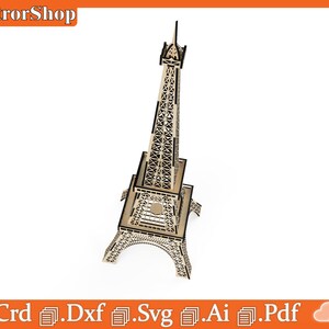 Puede incluir: Un modelo de la Torre Eiffel de madera cortado con l&aacute;ser. El modelo est&aacute; detallado con dise&ntilde;os intrincados y est&aacute; listo para ser ensamblado.