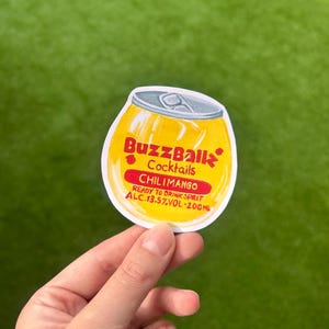 May include: A yellow and silver can-shaped sticker for BuzzBallz Cocktails. The sticker reads "ChiliMango" and "Ready to Drink Spirit" with an alcohol content of 13.5% and a volume of 200ml.