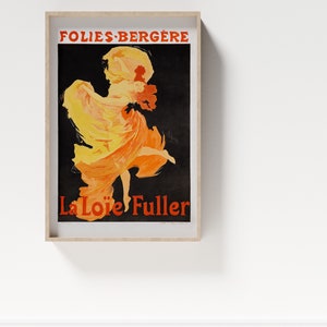 May include: A vintage poster advertising a performance by La Loie Fuller at the Folies-Berg&egrave;re. The poster features a woman in a flowing yellow and orange dress, dancing on a black background.