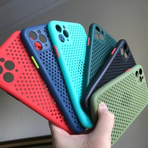May include: A set of six phone cases in various colors, including red, blue, green, and black. The cases have a grid pattern and are designed to protect a smartphone.
