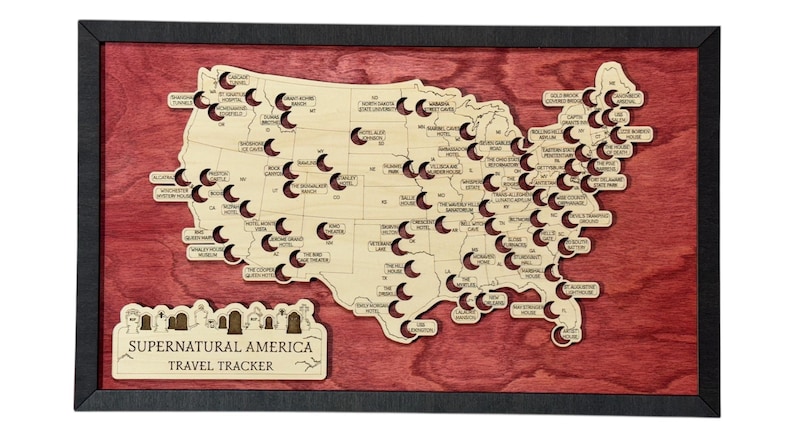 May include: Wooden map of the United States with a red background and black frame. The map is laser-cut with locations labeled, and the text "Supernatural America Travel Tracker" is at the bottom.