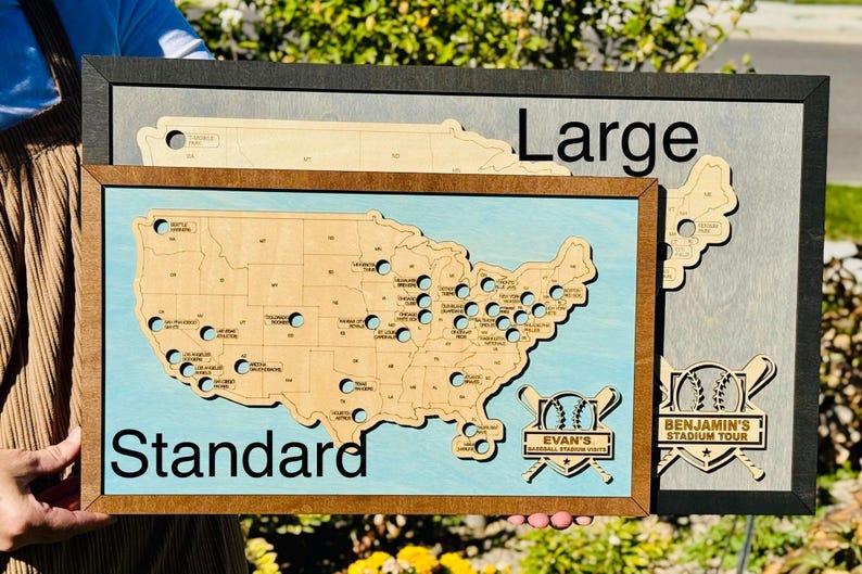 May include: Wooden map of the United States with baseball stadium locations. The map is framed in wood and has a light blue background. The text "Standard" and "Large" are visible. The map includes the text "Evan's Baseball Stadium Visits" and "Benjamin's Stadium Tour".