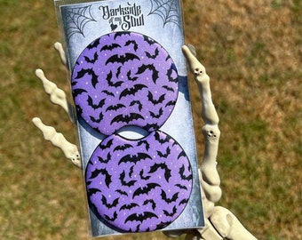 May include: Two purple round coasters with a black bat pattern. The coasters are packaged in a clear plastic bag with a white label that says "Darkside of my Soul".