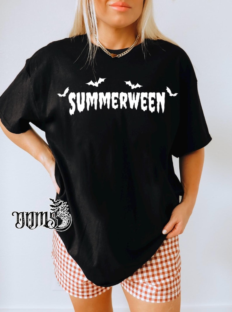 May include: Black t-shirt with the word "SUMMERWEEN" in white, featuring bat silhouettes above the text. The shirt is paired with brown and white checkered shorts. The overall theme is a blend of summer and Halloween.
