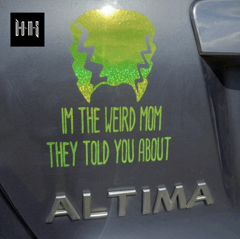 May include: A green glitter sticker on a gray car that says "I'm the weird mom they told you about".