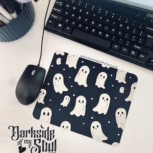 May include: A black mouse pad with a white ghost pattern and white dots. The text "www.DarksideOfMySoul.com" is printed in white on the mouse pad.