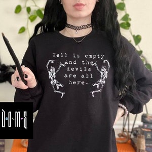 May include: Black sweatshirt with a white graphic print of two skeletons dancing with the text "Hell is empty and the devils are all here."