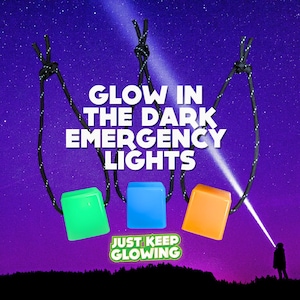 May include: Three glow-in-the-dark emergency lights hanging from black cords against a starry night sky. The lights are square and come in green, blue, and orange. The text "JUST KEEP GLOWING" is below the lights.