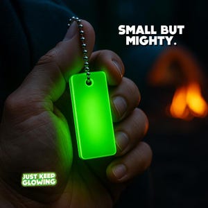 Glow in the dark keychain shown in hand – compact but powerful survival and camping gear.