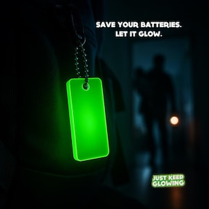Glow in the dark keychain glowing in dark hallway – save flashlight and phone batteries during blackout.