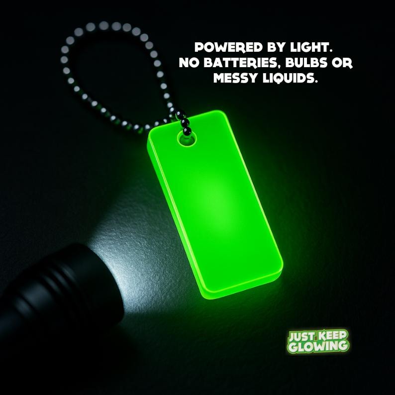 Glow in the dark keychain charging with bright flashlight – reusable light source powered by any light.