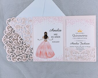 May include: Pink and white Quinceañera invitation with a gold crown and the text "Join us for a Quinceañera Celebration in honor of Amelia Jackson". The invitation includes the date and time of the event, the location, and a pink and white illustration of a girl in a princess dress.