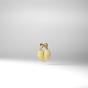 May include: A gold-tone pendant necklace featuring two interlocking heart charms, each with a crack down the center. The hearts are joined together at the top, creating a single pendant.