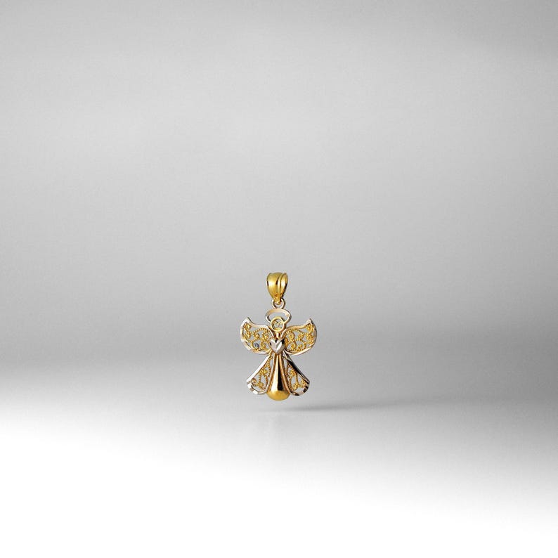 May include: A gold angel pendant with intricate details. The angel is made of two-toned gold, with a yellow gold body and white gold wings.