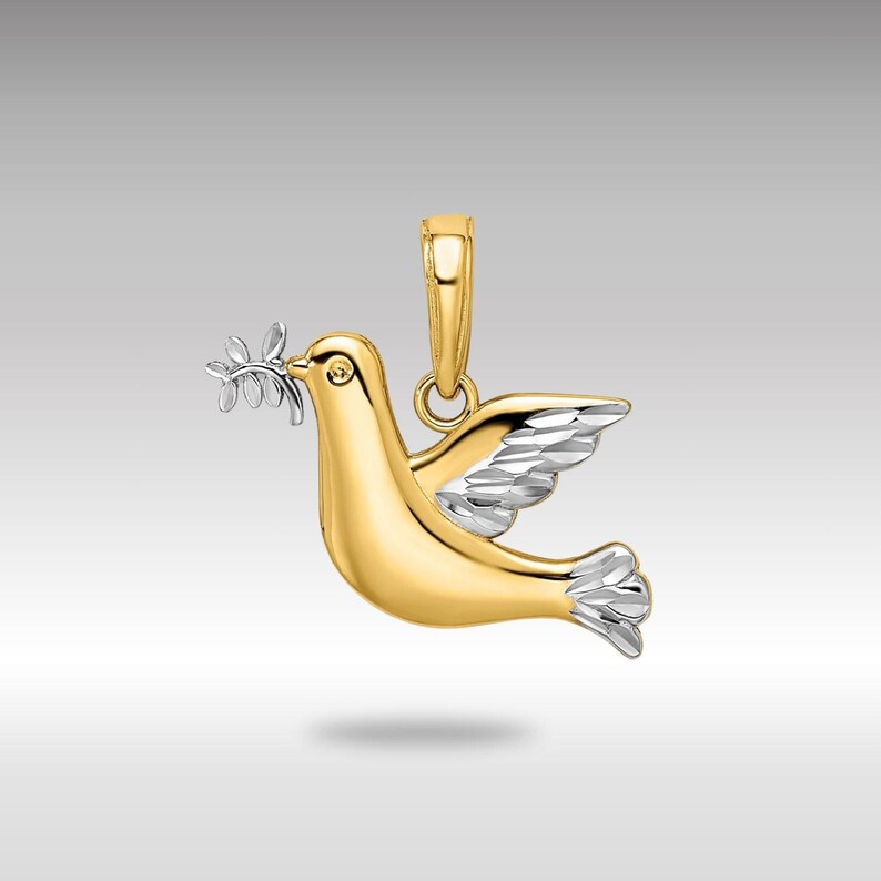 May include: A gold and silver dove pendant with an olive branch in its beak. The dove is a symbol of peace.