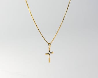 May include: A gold chain necklace with a two-tone cross pendant. The cross is made of gold and silver.