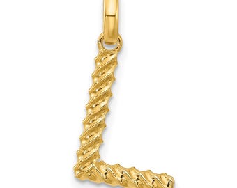 May include: A gold-coloured pendant in the shape of the letter "L". The pendant has a textured, twisted rope design. The top of the letter has a small loop for attaching to a chain or bracelet. The pendant is likely made of gold.