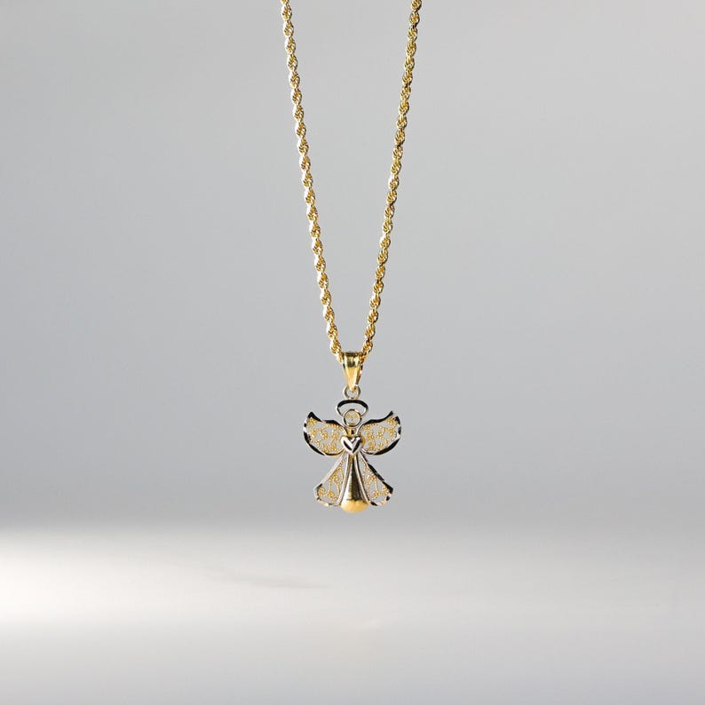 May include: A gold chain necklace with a two-tone angel pendant. The angel is made of silver with gold accents.