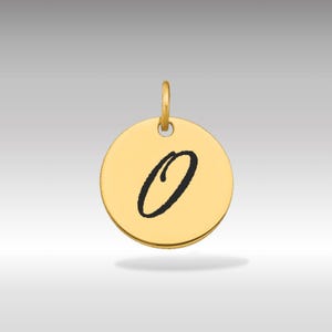 Pode incluir: Pingente redondo dourado com a letra cursiva preta "O" no centro. O pingente tem uma pequena argola na parte superior para prender a uma corrente. Fundo gradiente cinza claro.