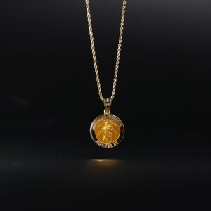 May include: A gold chain necklace with a round pendant featuring a religious image of Saint Jude Thaddeus. The pendant has the words "Saint Jude Thaddeus" and "Pray for Us" inscribed on it.