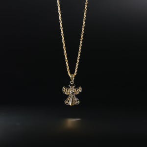 May include: A gold chain necklace with an angel pendant. The angel is made of gold and has a delicate, intricate design.