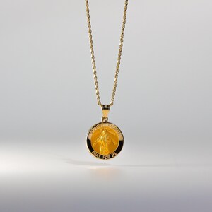May include: A gold chain necklace with a round pendant featuring a depiction of Saint Jude Thaddeus. The pendant has the words "St. Jude Thaddeus" and "Pray for Us" inscribed on it.