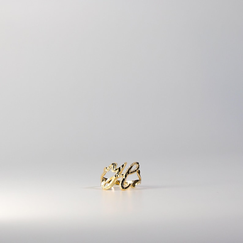 May include: A gold ring with the word "wife" written in cursive.