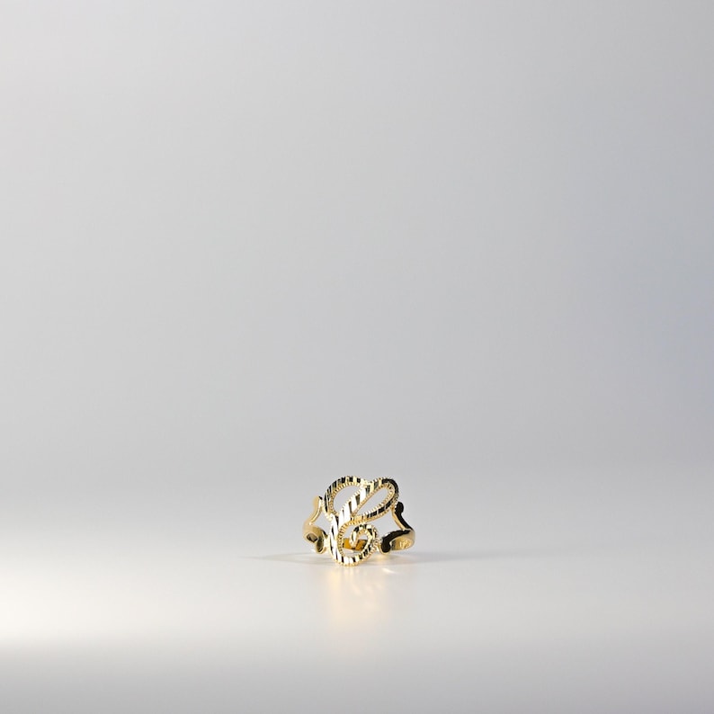 May include: A gold ring with a stylized letter 'L' design.