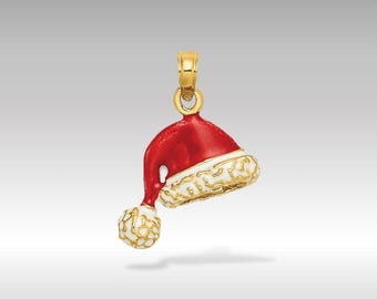 May include: A gold-coloured Santa hat charm with a red crown and white trim. The charm has a gold bail for attaching to a necklace or bracelet. The hat's pom-pom is also white and gold. A festive Christmas-themed jewellery piece.